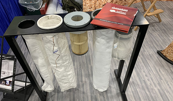 Dust collection filters on display at the American Fabric Filter booth