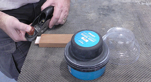 A worker uses Eagle Kovax Dry Coat Guide to mark a tenon